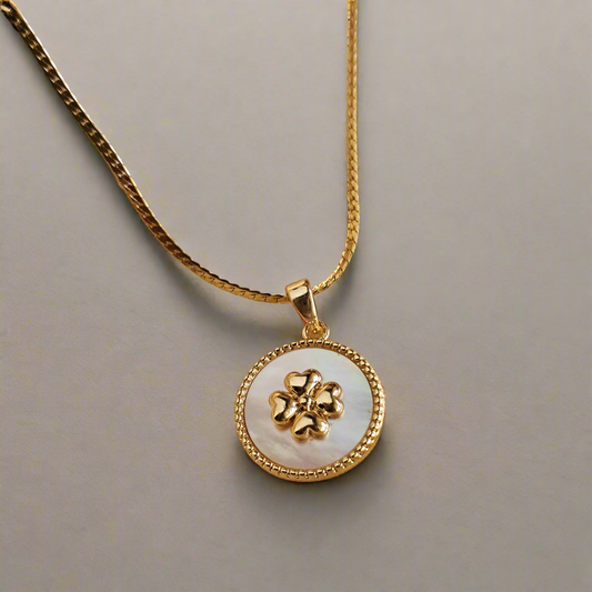 Minimalist clover charm necklace on white background