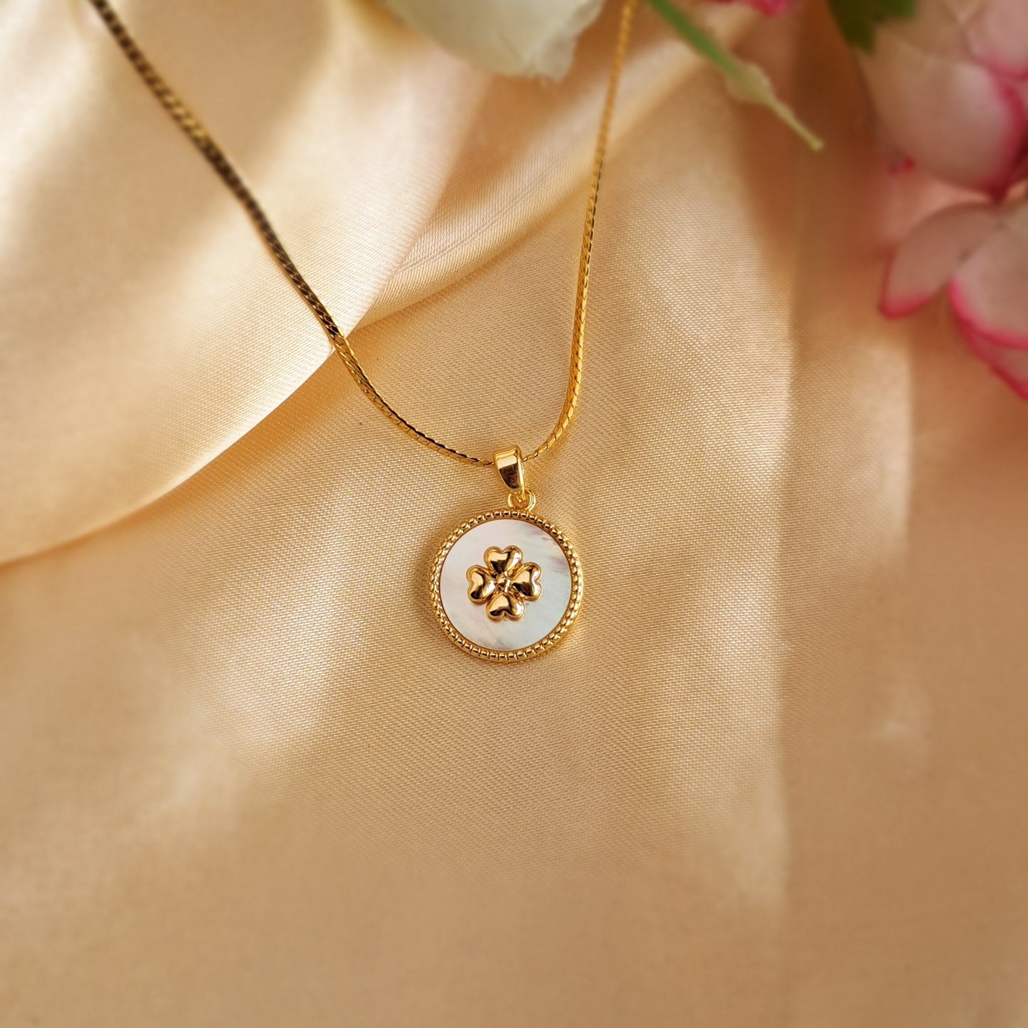 Golden four-leaf clover necklace close-up
