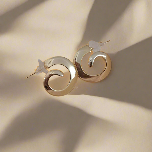Gold-tone spiral hoop earrings elegant design display
