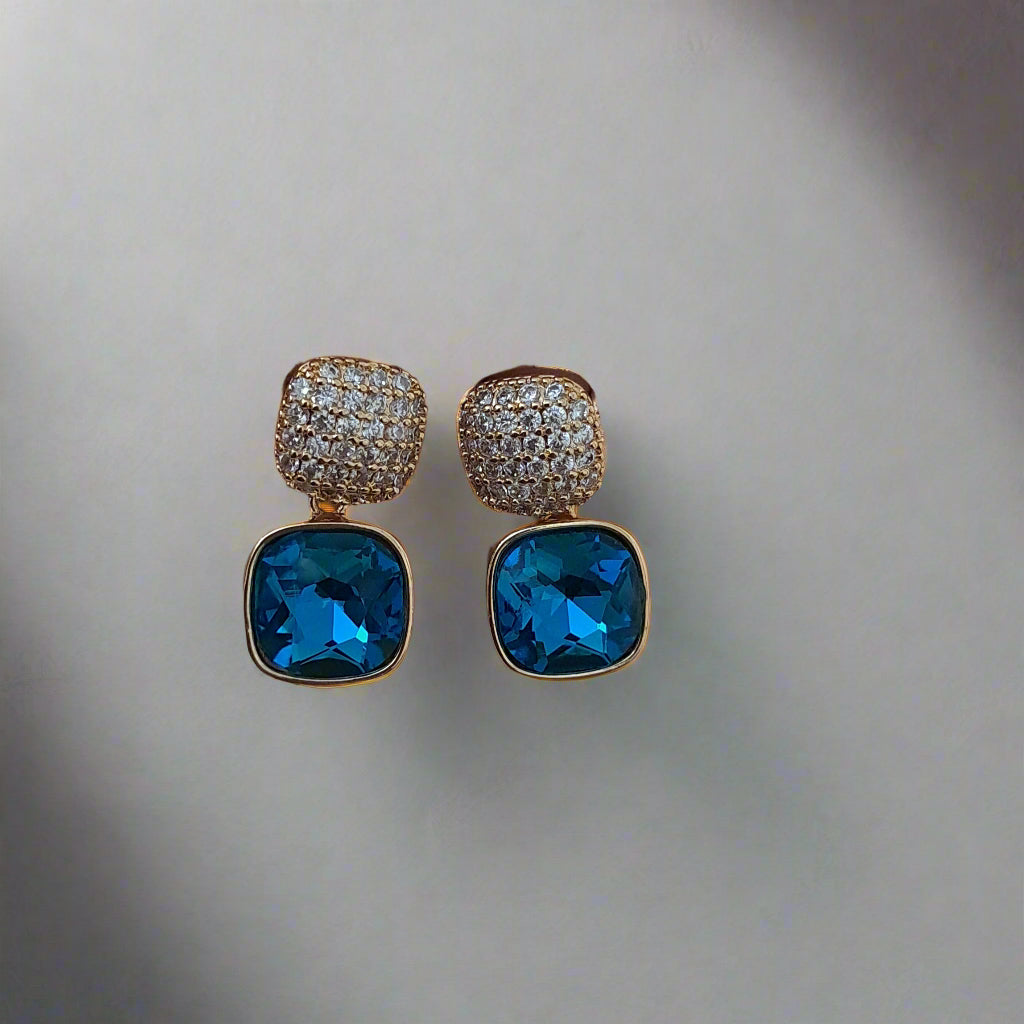 Blue stone earrings in golden settings