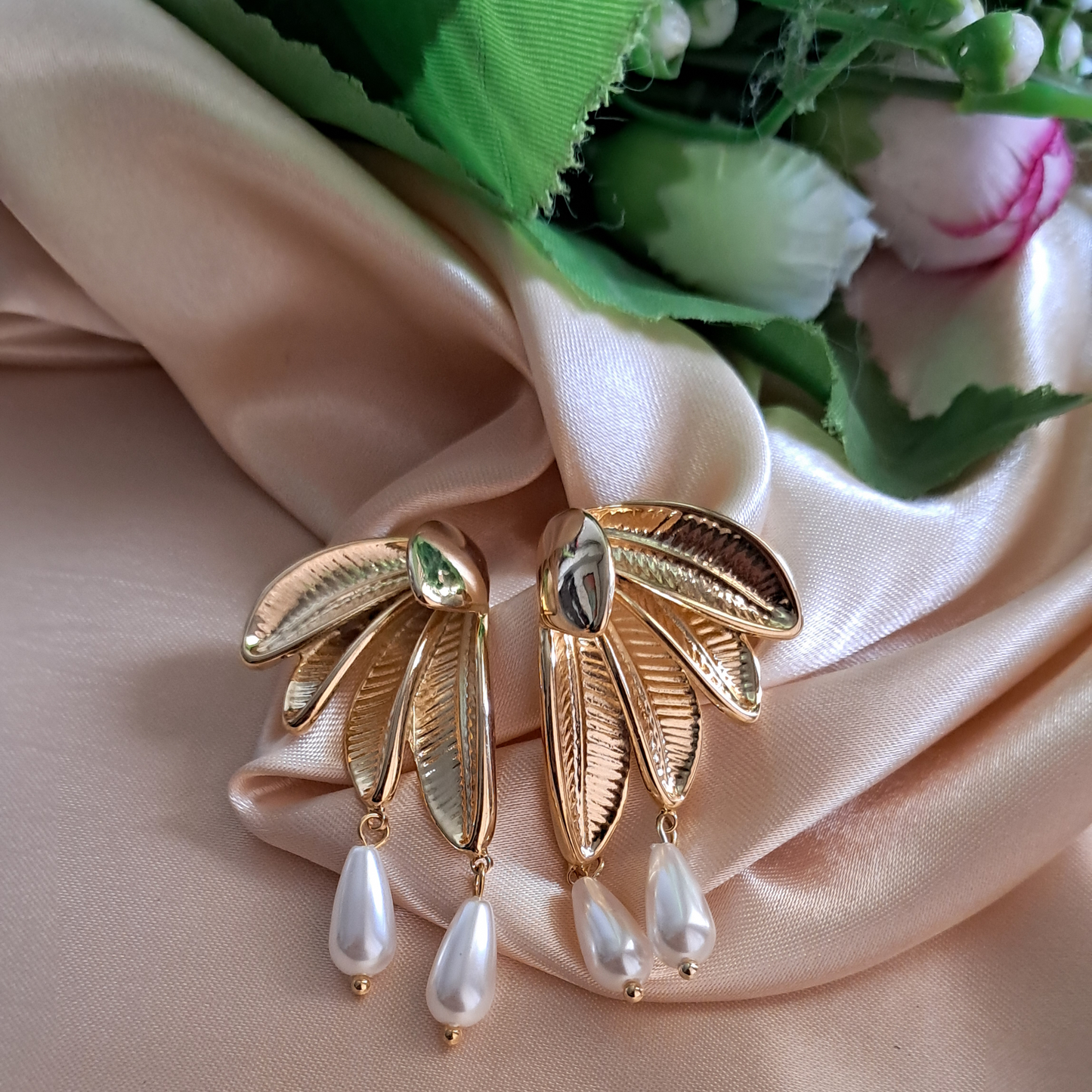 White pearl leaf earrings gold-tone finish elegant display