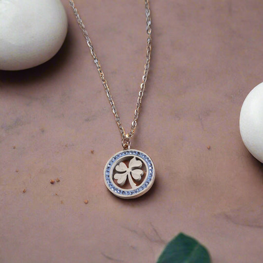 Golden clover leaf necklace with stone-studded circle pendant