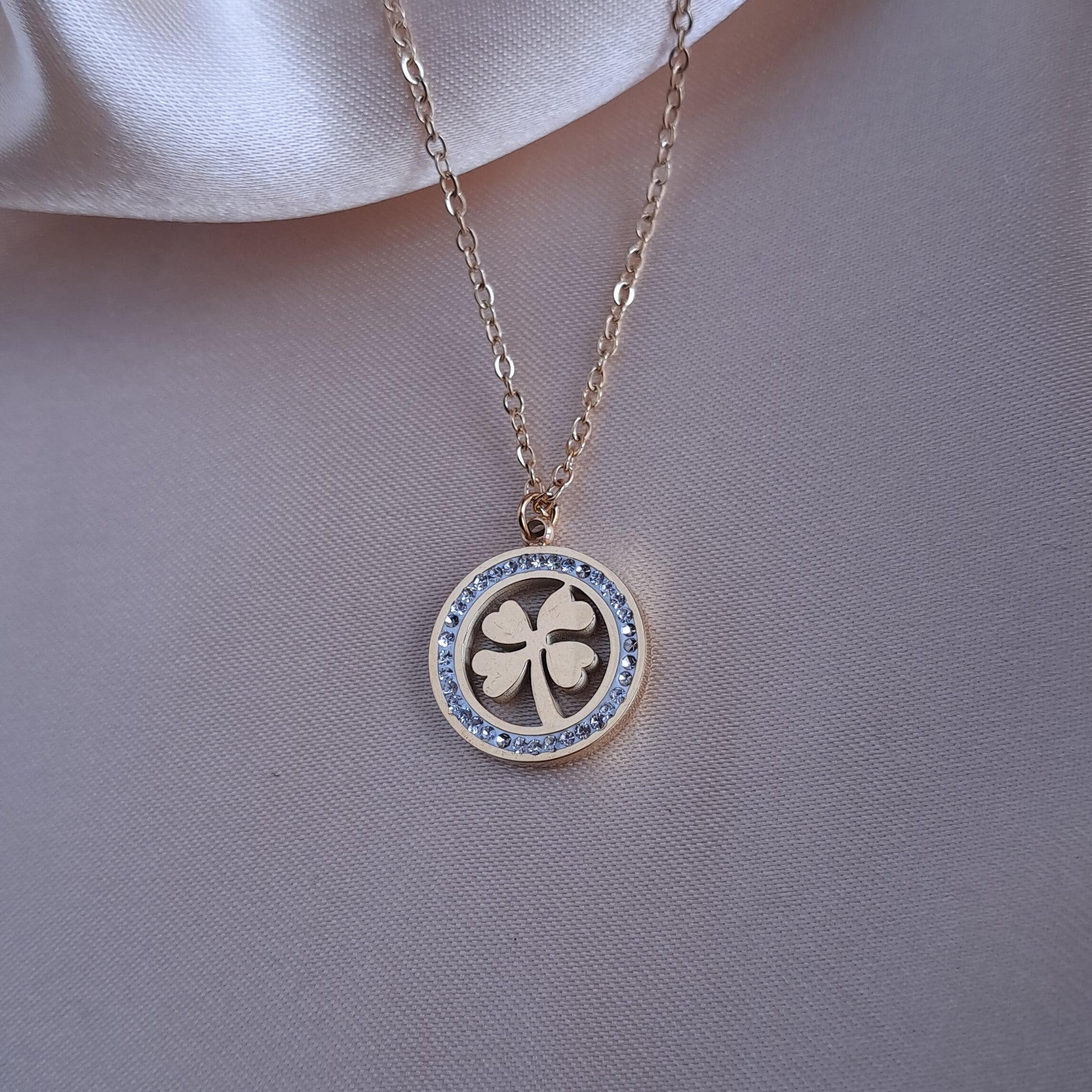 Close-up of clover leaf pendant with stone details