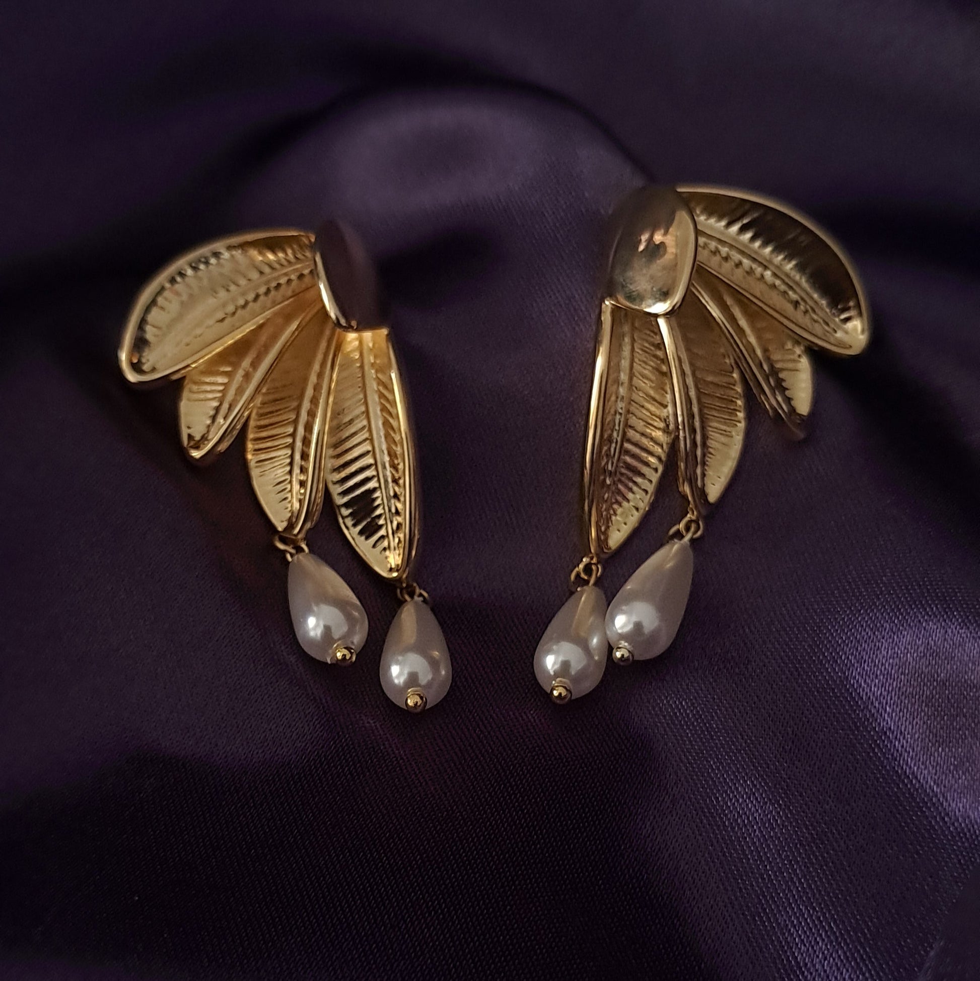 Gold-tone leaf design earrings with elegant white pearls