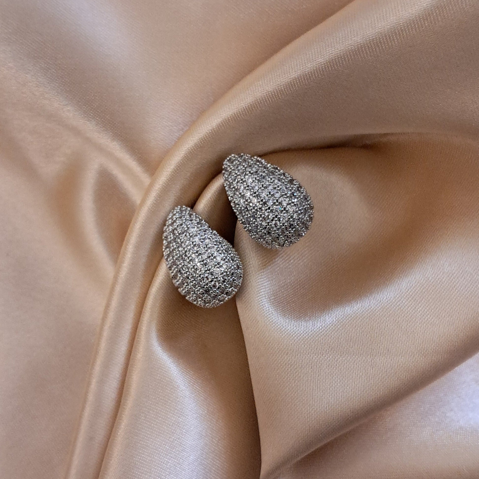 Silver shade tear drop earrings with intricate AD design