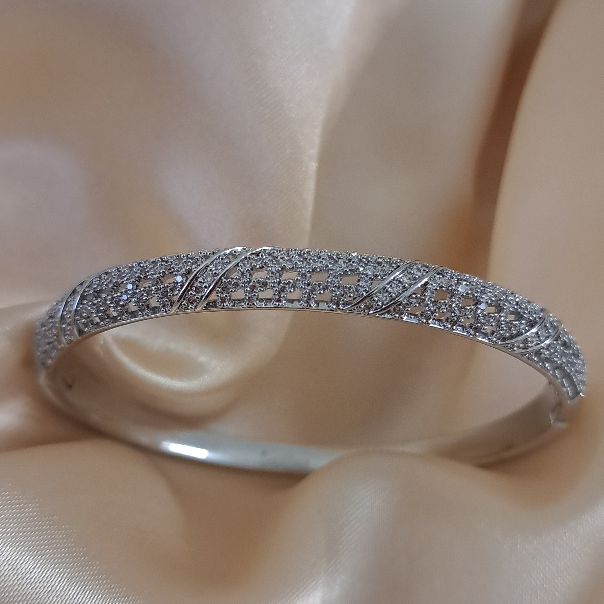 Silver shade bracelet with intricate American diamond detailing